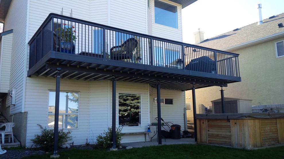Mid-sized transitional backyard deck photo in Calgary with a fire pit and no cover