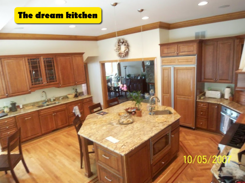 Enclosed kitchen - large u-shaped light wood floor and multicolored floor enclosed kitchen idea in Baltimore with an undermount sink, beaded inset cabinets, medium tone wood cabinets, granite countertops, paneled appliances, an island and multicolored countertops