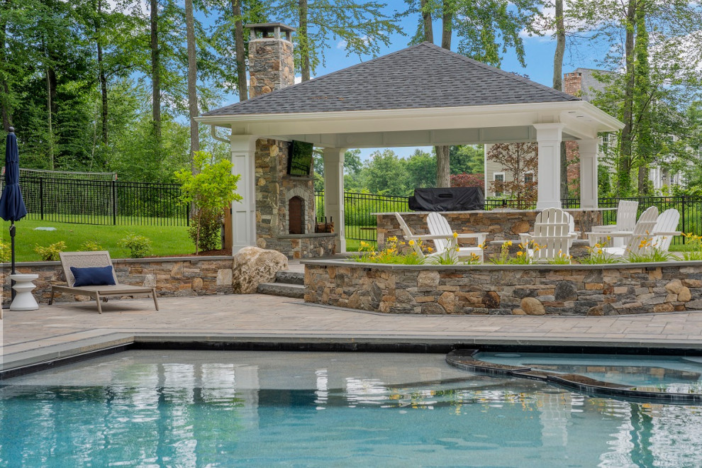 Photo of a large modern backyard rectangular infinity pool in Bridgeport with a hot tub and concrete pavers.