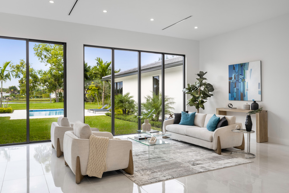 Contemporary living room in Miami with white walls and white floor.