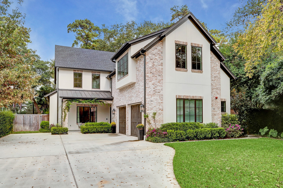 Photo of a transitional two-storey brick white house exterior in Houston with a gable roof, a mixed roof and a grey roof.