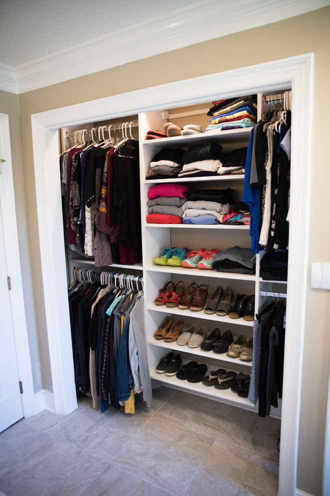 Inspiration for a mid-sized transitional gender-neutral built-in wardrobe in Indianapolis with open cabinets, white cabinets and travertine floors.