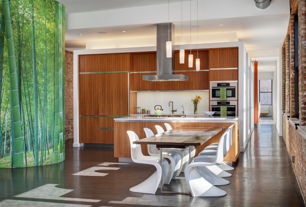 This is an example of a mid-sized contemporary single-wall eat-in kitchen in Chicago with flat-panel cabinets, medium wood cabinets, white splashback, stainless steel appliances, with island, quartz benchtops, an undermount sink, ceramic floors and grey floor.