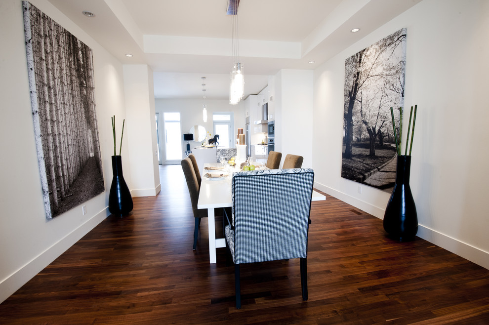 Inspiration for a contemporary kitchen/dining combo in Calgary with white walls and dark hardwood floors.