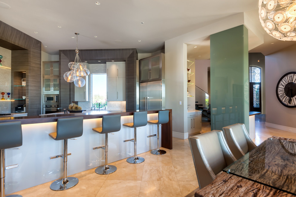 This is an example of a large contemporary u-shaped eat-in kitchen in Houston with an undermount sink, flat-panel cabinets, medium wood cabinets, solid surface benchtops, grey splashback, glass sheet splashback, stainless steel appliances, porcelain floors, with island and beige floor.