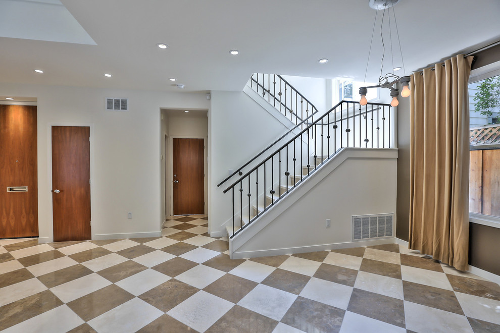 Design ideas for a traditional travertine l-shaped staircase in San Francisco with travertine risers and metal railing.