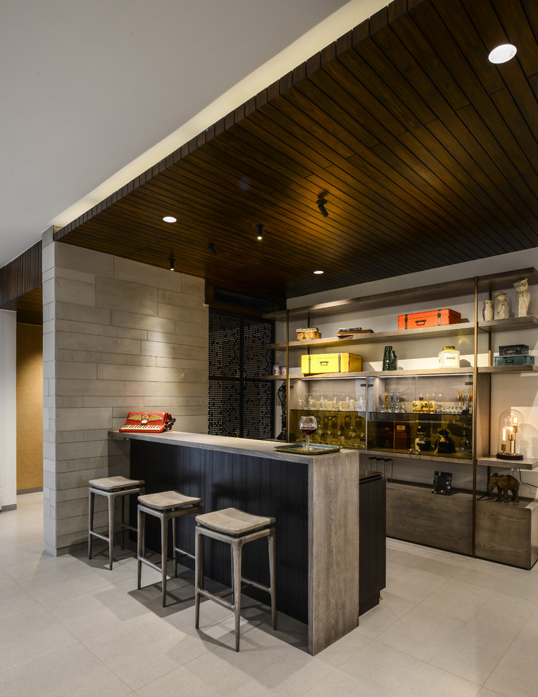 Design ideas for a contemporary home bar in Hyderabad.
