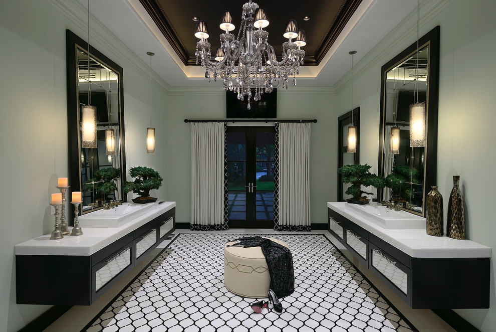 Photo of a large mediterranean bathroom in Miami with flat-panel cabinets, dark wood cabinets, black and white tile, green walls, porcelain floors and a vessel sink.