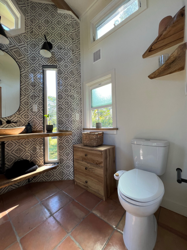 Mid-sized cottage master black and white tile and ceramic tile terra-cotta tile, single-sink and exposed beam bathroom photo in Hawaii with open cabinets, light wood cabinets, wood countertops, beige countertops, a niche and a floating vanity