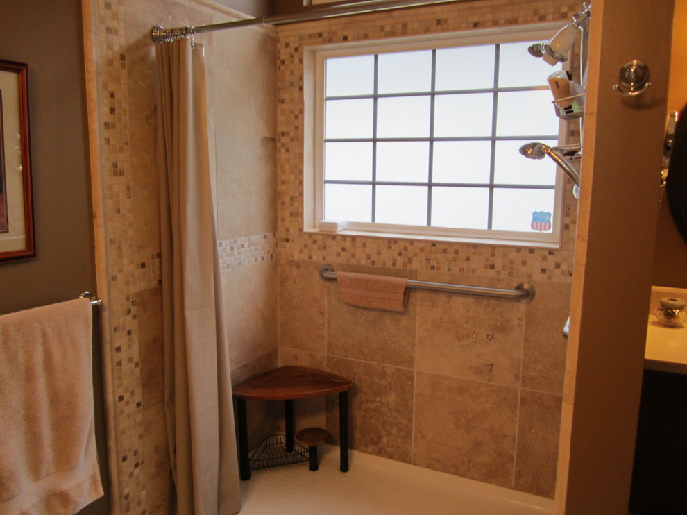 Mid-sized traditional bathroom in Cleveland with an undermount sink, raised-panel cabinets, medium wood cabinets, solid surface benchtops, a two-piece toilet, stone tile, beige walls and ceramic floors.