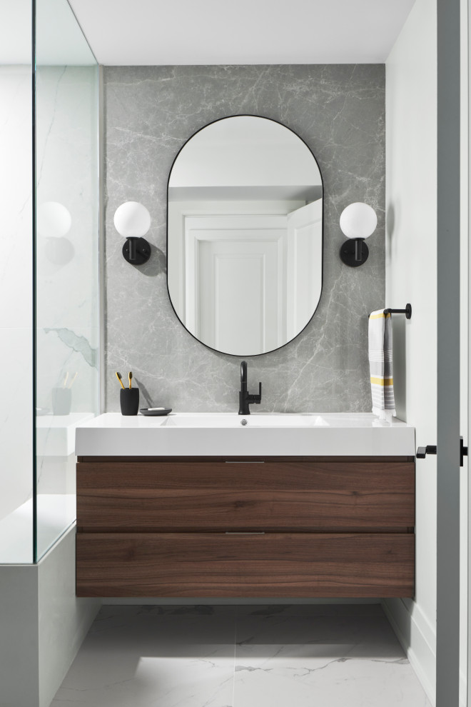 Inspiration for a mid-sized contemporary 3/4 bathroom in Toronto with flat-panel cabinets, brown cabinets, a curbless shower, a one-piece toilet, gray tile, porcelain tile, white walls, porcelain floors, an integrated sink, solid surface benchtops, white floor, a hinged shower door, white benchtops, a niche, a single vanity and a floating vanity.