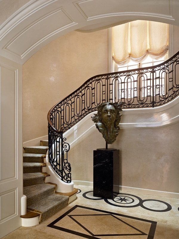Example of a tuscan wooden curved staircase design in Chicago with painted risers