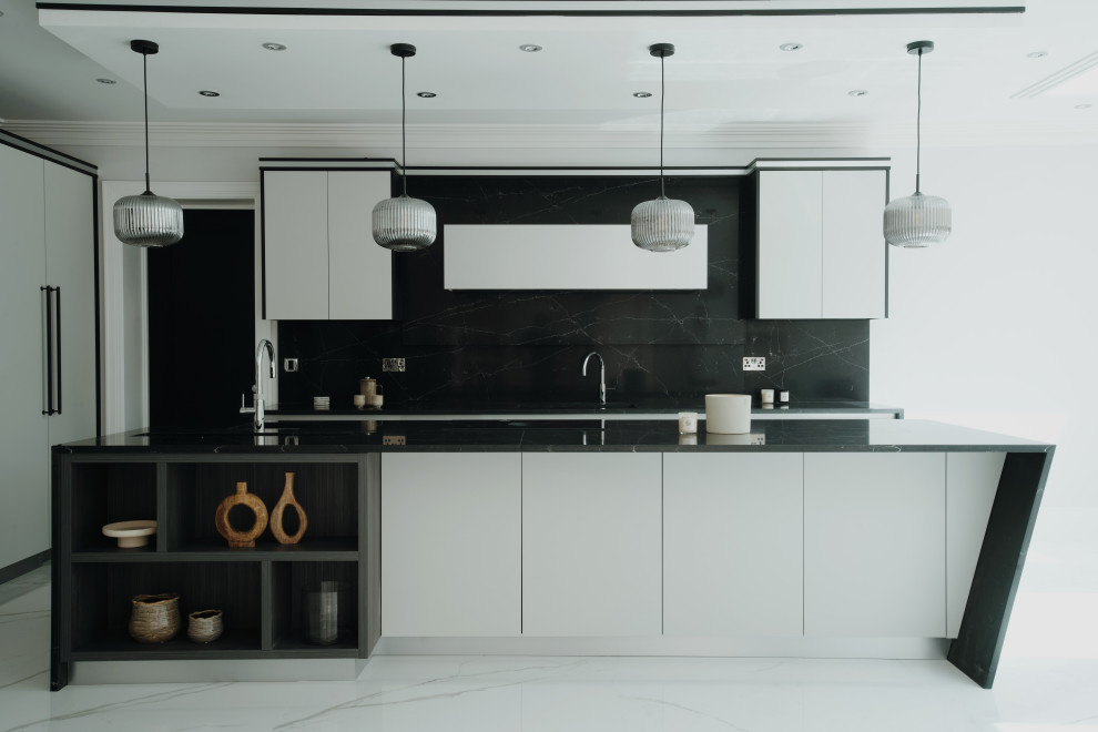 Inspiration for a large modern grey and black l-shaped kitchen/diner in Surrey with a built-in sink, flat-panel cabinets, grey cabinets, composite countertops, black splashback, engineered quartz splashback, black appliances, porcelain flooring, an island, white floors, black worktops, a coffered ceiling and feature lighting.