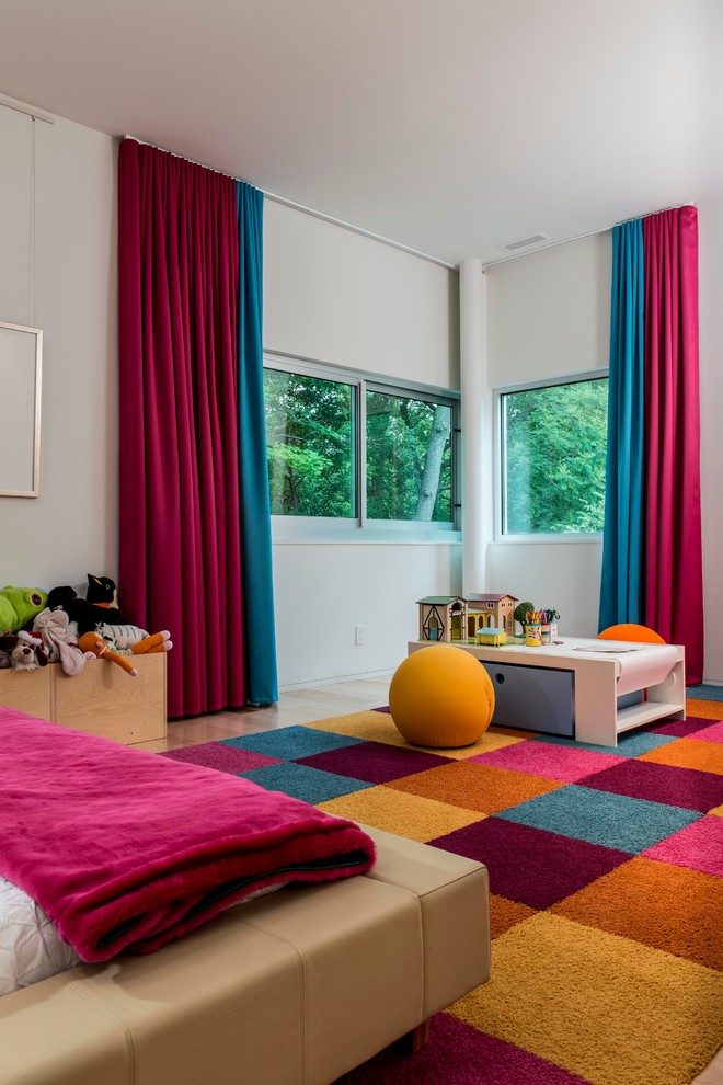 Inspiration for a contemporary gender-neutral kids' playroom for kids 4-10 years old in Indianapolis with white walls and light hardwood floors.