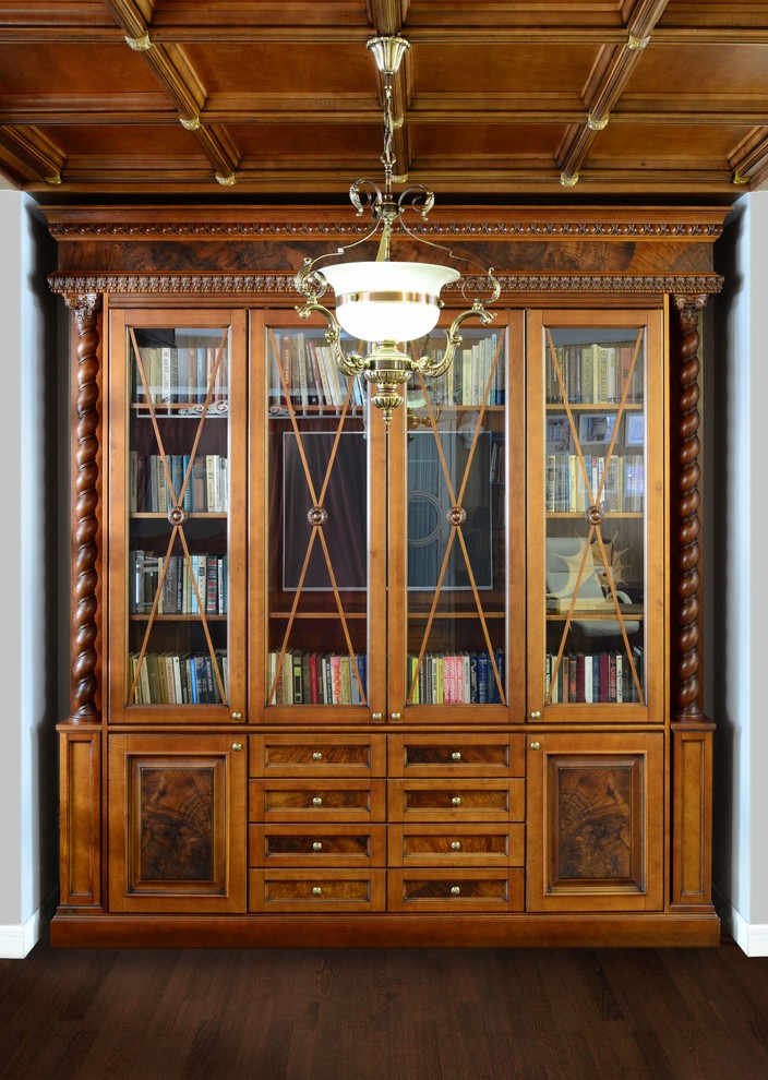 Large traditional home office in Other with a library, white walls, laminate floors, a freestanding desk and brown floor.