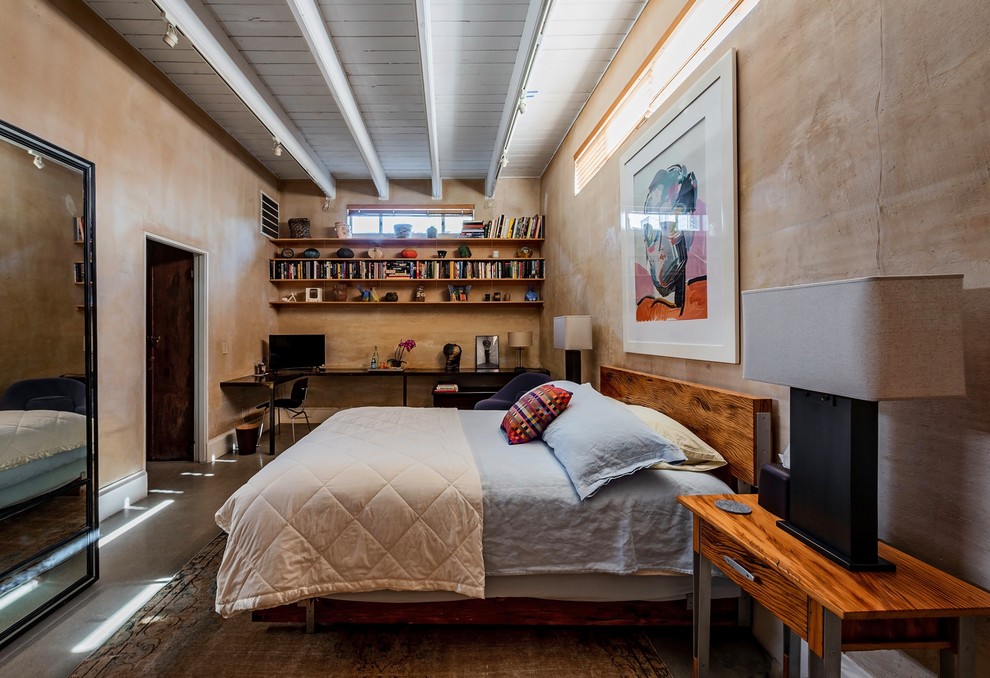 Contemporary bedroom in Los Angeles with brown walls, concrete floors and grey floor.