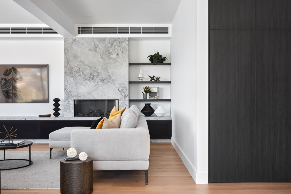 Inspiration for a medium sized contemporary open plan living room in Sydney with white walls, light hardwood flooring, a standard fireplace, a stone fireplace surround and a wall mounted tv.