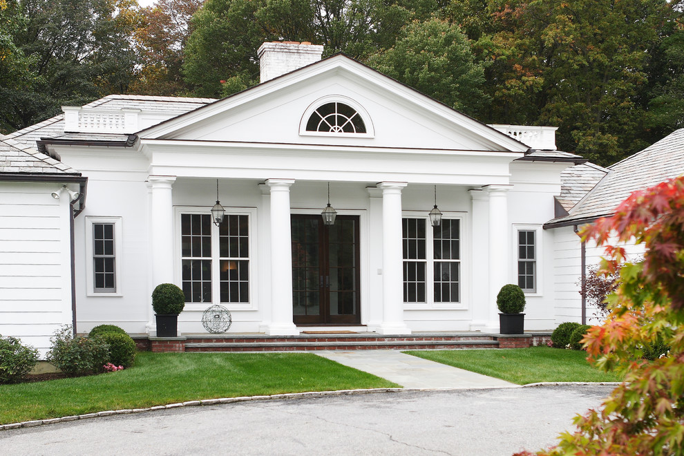 Expansive traditional one-storey white exterior in New York with wood siding and a hip roof.