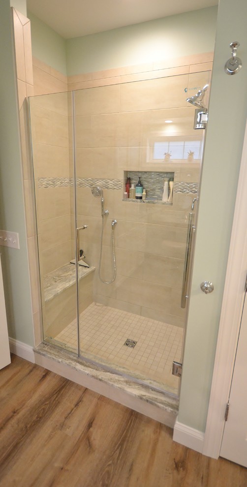 Large transitional master bathroom in Philadelphia with raised-panel cabinets, white cabinets, a corner shower, a one-piece toilet, beige tile, ceramic tile, vinyl floors, an undermount sink, granite benchtops, brown floor, a hinged shower door and multi-coloured benchtops.