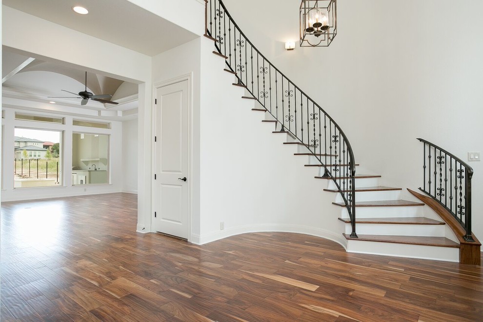 Inspiration for a large traditional foyer in Austin with white walls, bamboo floors, a double front door, a dark wood front door and brown floor.