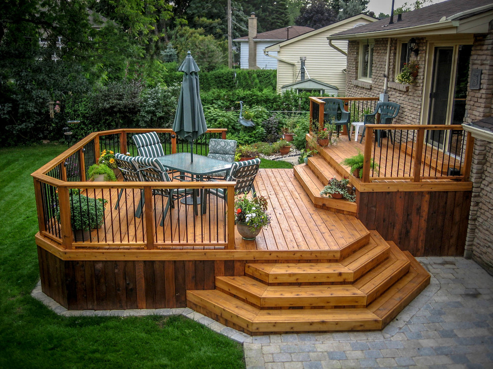 This is an example of a mid-sized traditional backyard deck in Toronto with no cover.