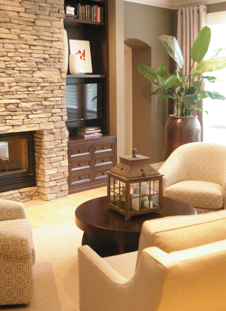 This is an example of a mid-sized transitional enclosed living room in Other with a music area, grey walls, carpet, beige floor, a two-sided fireplace, a stone fireplace surround and a freestanding tv.