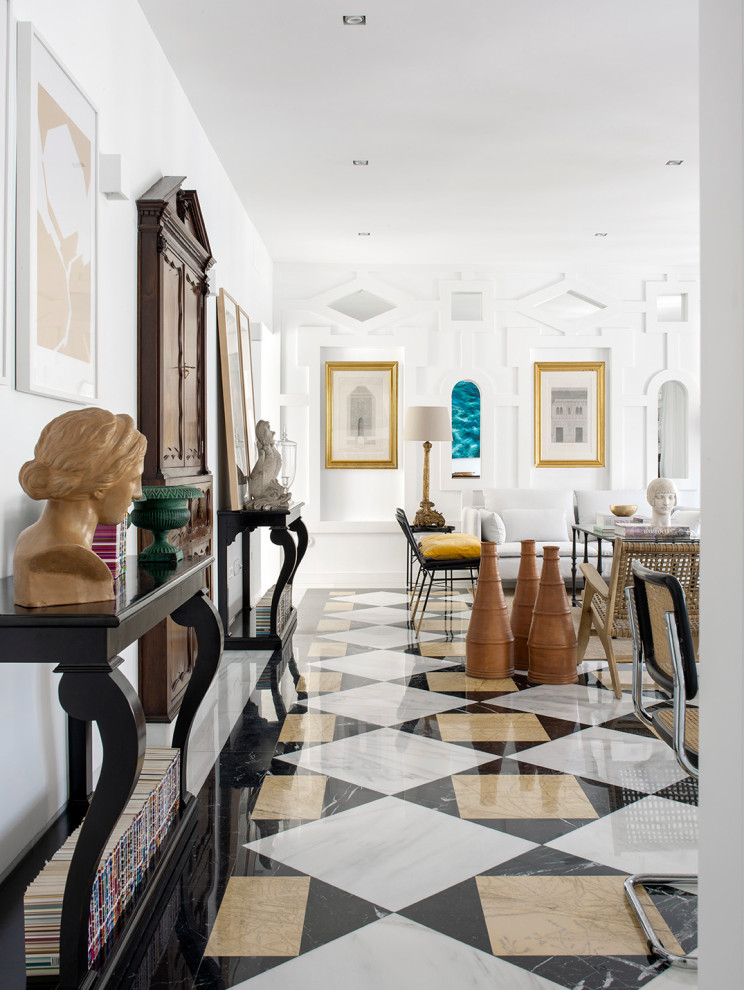 This is an example of a large mediterranean open concept living room in Seville with white walls, marble floors, no fireplace, white floor and decorative wall panelling.
