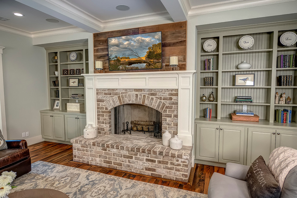 Design ideas for a large transitional formal open concept living room in Atlanta with dark hardwood floors, a standard fireplace, a brick fireplace surround, a wall-mounted tv and grey walls.