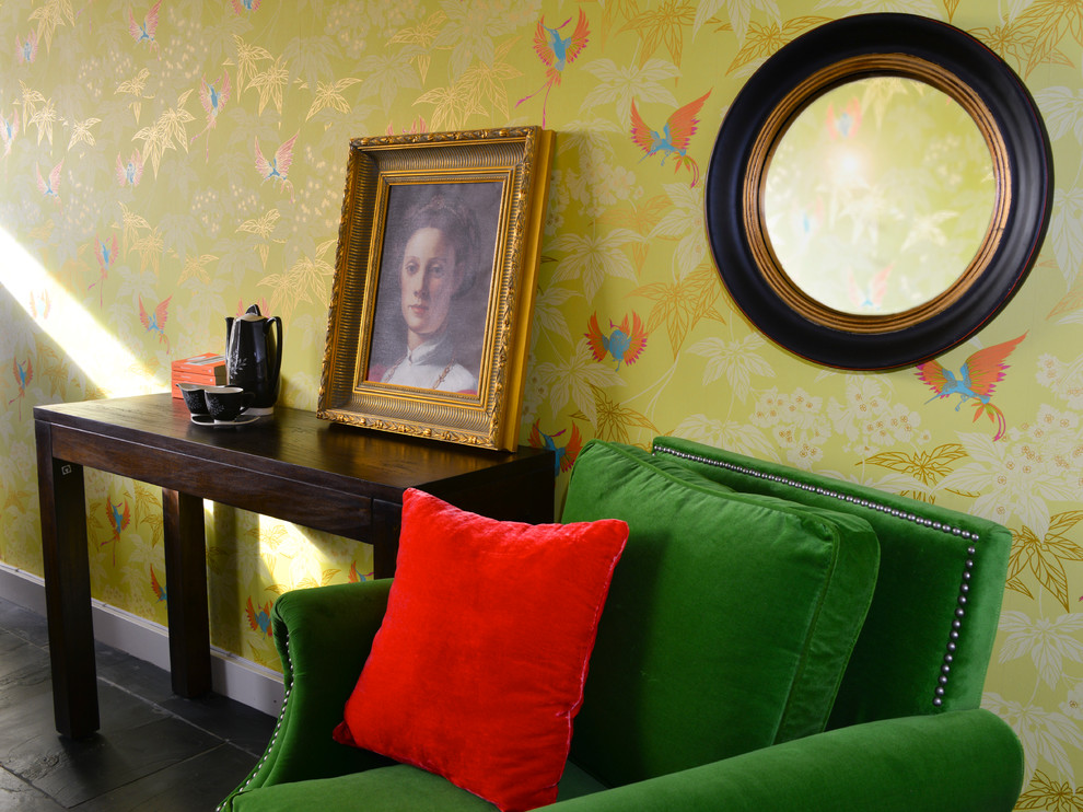 This is an example of a mid-sized eclectic living room in London with green walls.