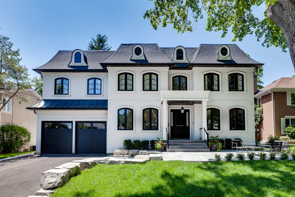 Large transitional three-storey white exterior in Toronto with a hip roof.