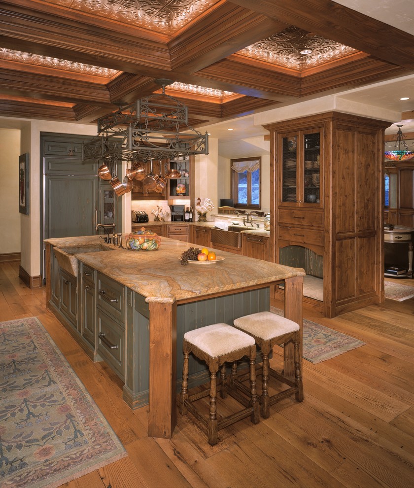 Inspiration for a large country u-shaped eat-in kitchen in Denver with a farmhouse sink, raised-panel cabinets, distressed cabinets, granite benchtops, multi-coloured splashback, panelled appliances, medium hardwood floors and with island.