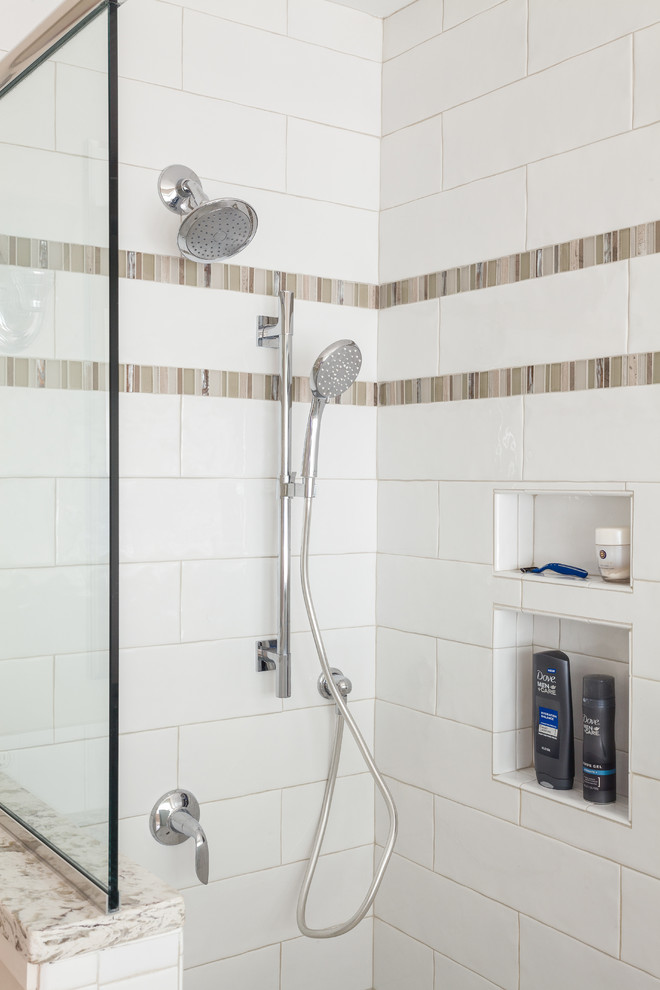 Photo of a mid-sized modern 3/4 bathroom in Boston with a corner shower, white tile, recessed-panel cabinets, white cabinets, a one-piece toilet, ceramic tile, beige walls, ceramic floors, an undermount sink and granite benchtops.