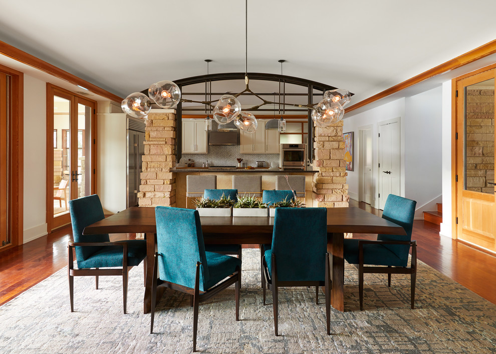 Photo of a large transitional open plan dining in Austin with white walls, medium hardwood floors and brown floor.