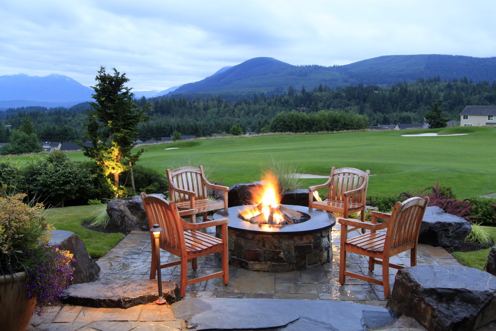 Design ideas for a large contemporary backyard patio in Seattle with a fire feature, natural stone pavers and no cover.