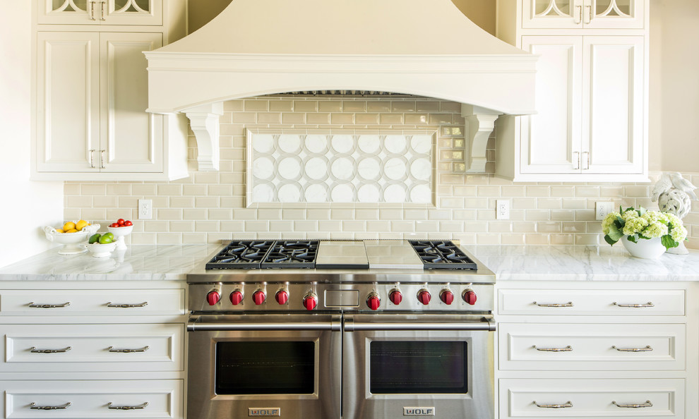 Example of a huge transitional u-shaped dark wood floor open concept kitchen design in Seattle with an undermount sink, beaded inset cabinets, white cabinets, marble countertops, gray backsplash, ceramic backsplash, stainless steel appliances and an island