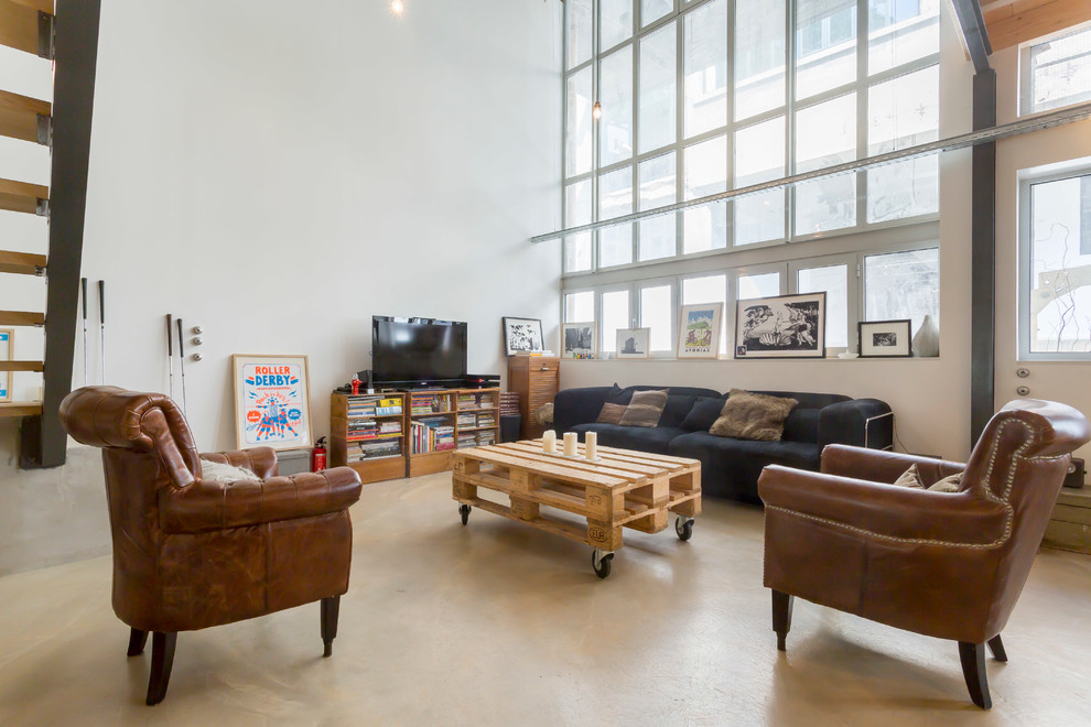 Large industrial open concept family room in Lyon with white walls, no fireplace and a freestanding tv.