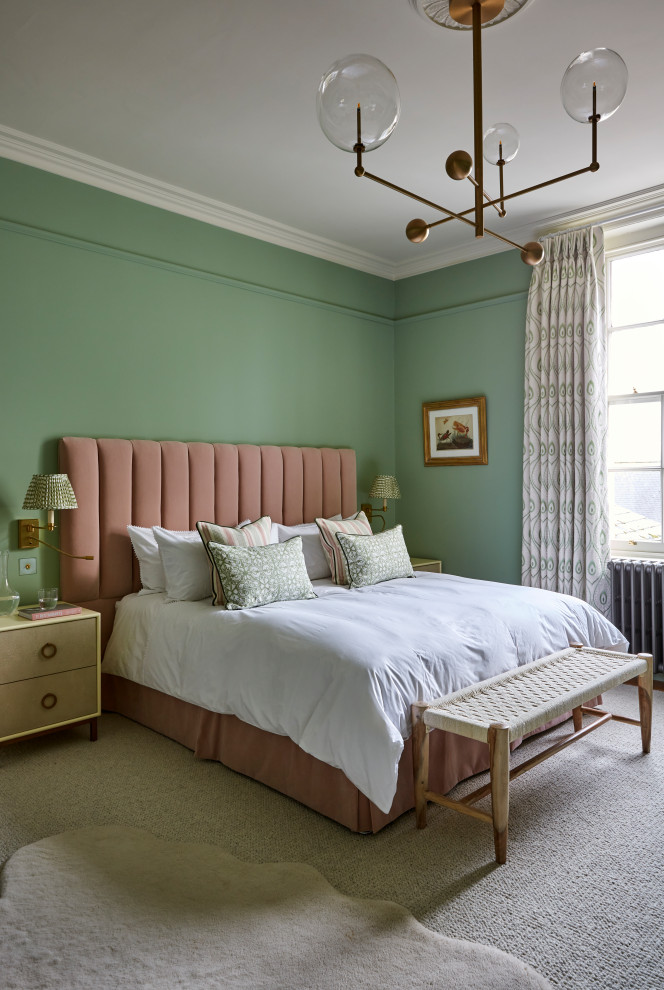 This is an example of a traditional bedroom in Gloucestershire with green walls, carpet and grey floors.