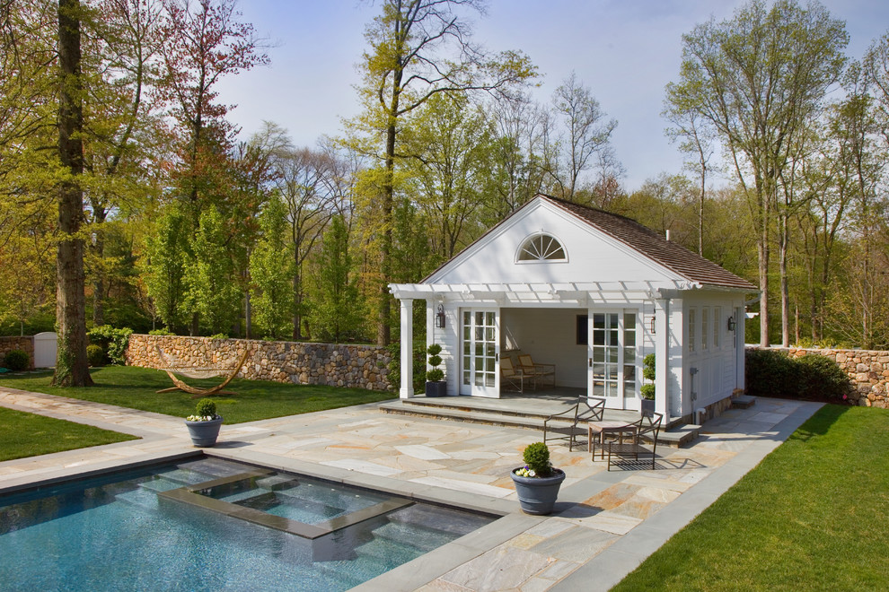 Photo of a traditional rectangular pool in New York with a pool house.