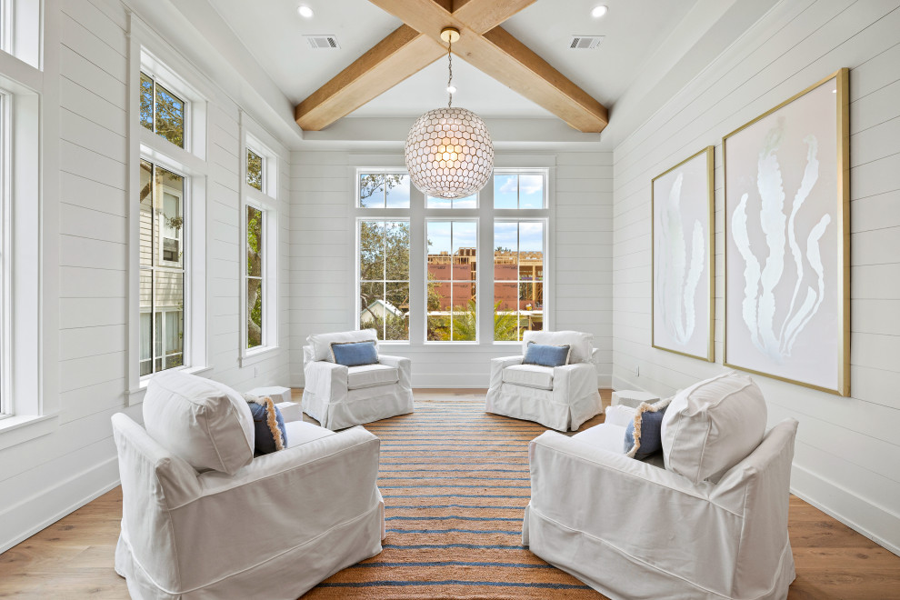 Inspiration for a beach style living room in Miami with white walls, light hardwood floors and planked wall panelling.