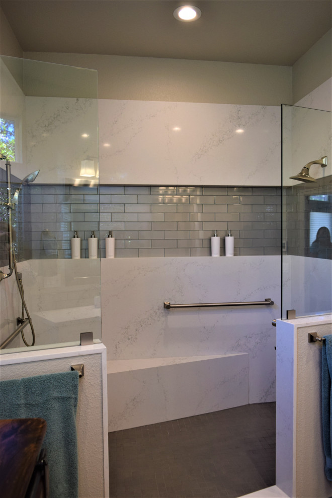 This is an example of a large transitional master bathroom in San Francisco with shaker cabinets, white cabinets, a double shower, a one-piece toilet, gray tile, glass tile, grey walls, porcelain floors, an undermount sink, engineered quartz benchtops, grey floor, an open shower, white benchtops, a shower seat, a double vanity and a built-in vanity.
