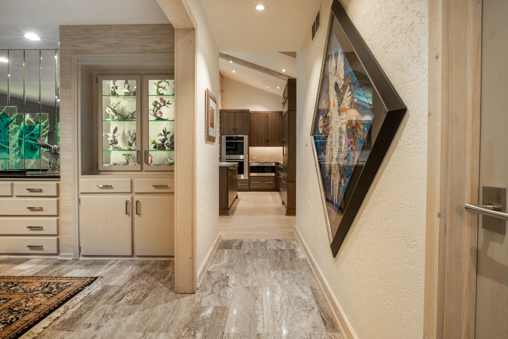 Inspiration for a large contemporary hallway in Indianapolis with beige walls, porcelain floors and beige floor.