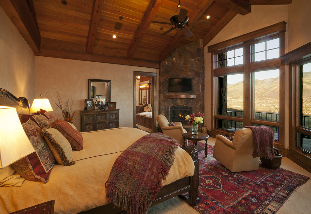 Country bedroom in Denver with a corner fireplace.