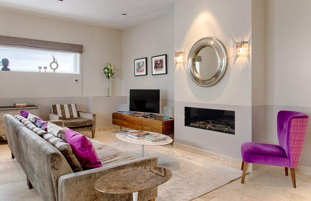 Design ideas for a mid-sized contemporary formal living room in London with grey walls, a standard fireplace and a freestanding tv.