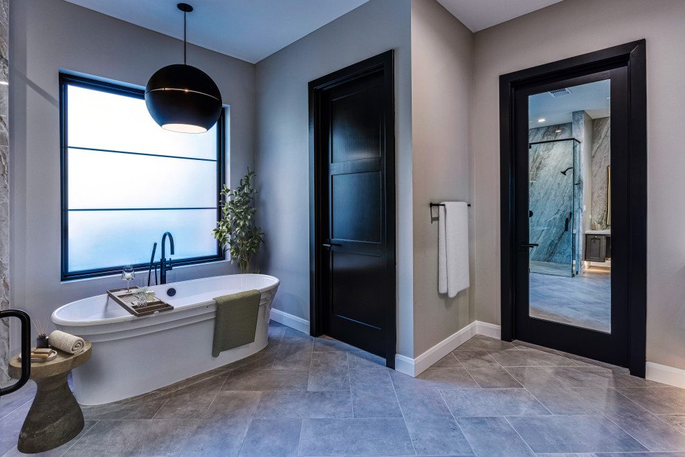 Freestanding Soaking Tub & Black Framed Window Primary Bathroom | French Country