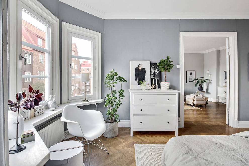 Inspiration for a scandinavian bedroom in Gothenburg with brown walls, medium hardwood floors and brown floor.