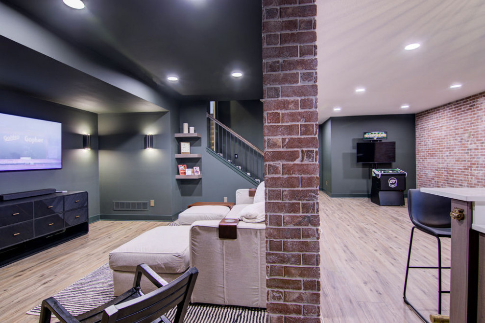 Inspiration for a large modern walk-out basement in Kansas City with a home bar, green walls, vinyl floors, exposed beam and brick walls.