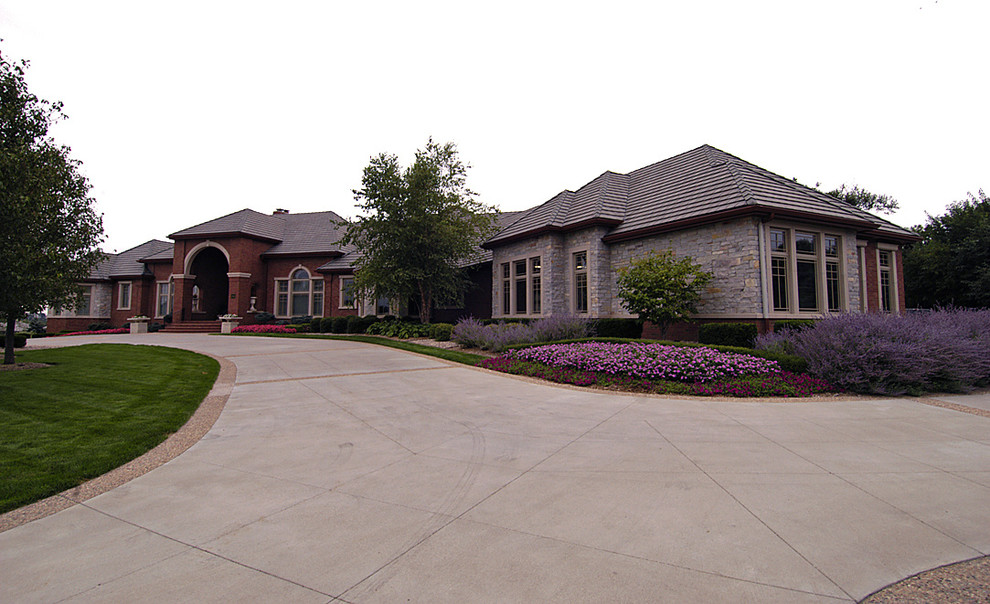Expansive transitional one-storey brick red exterior in Omaha.