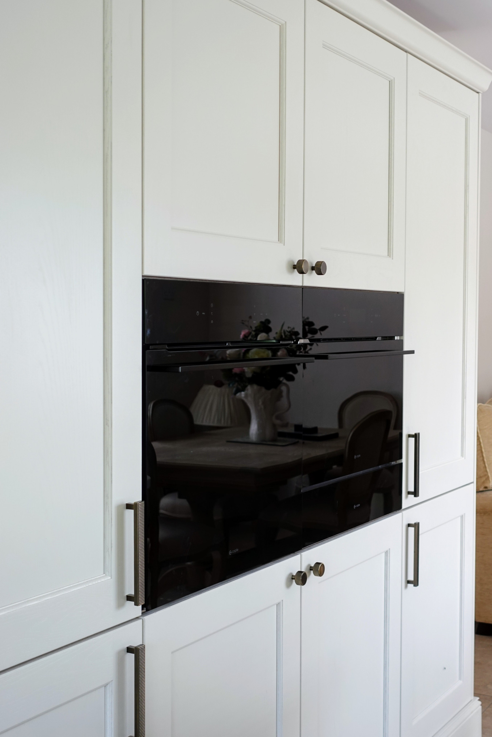 Open concept kitchen - large traditional single-wall porcelain tile and gray floor open concept kitchen idea in Other with a farmhouse sink, beaded inset cabinets, medium tone wood cabinets, quartzite