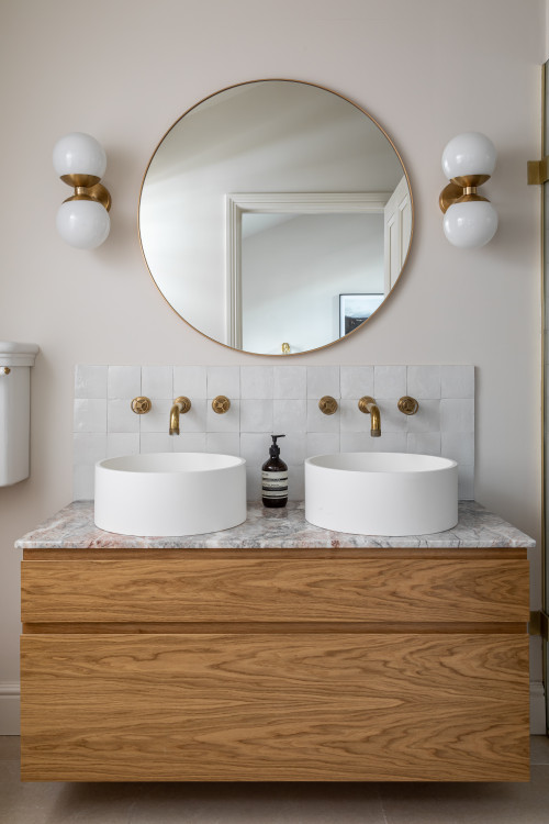 Wood Vanity with Gold Accents and Square Tile Backsplash