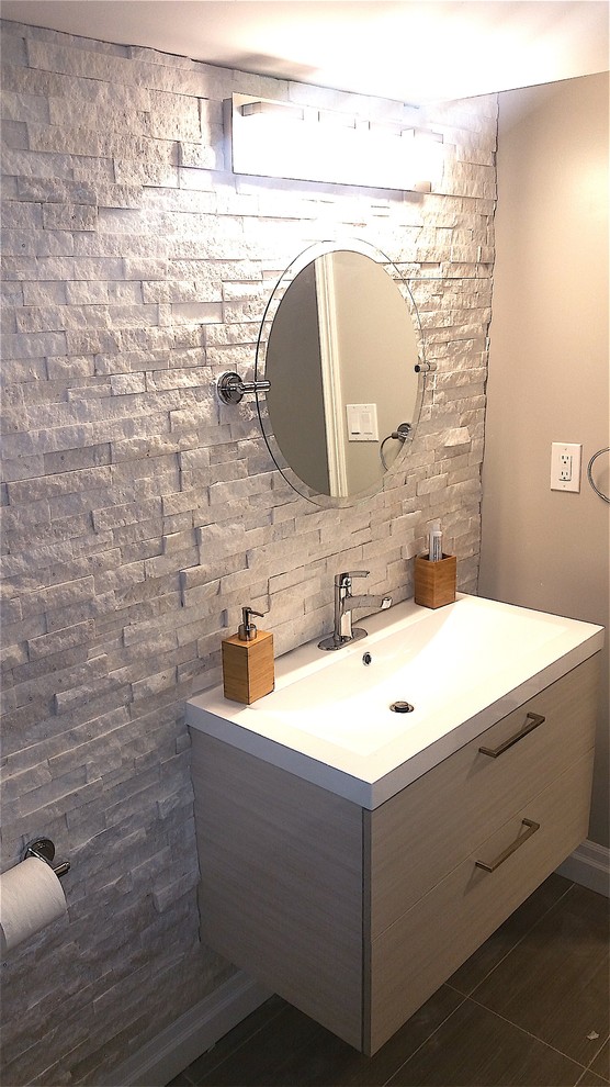 This is an example of a large contemporary master bathroom in Toronto with recessed-panel cabinets, white cabinets, a corner shower, a two-piece toilet, gray tile, grey walls, an undermount sink, engineered quartz benchtops and a hinged shower door.